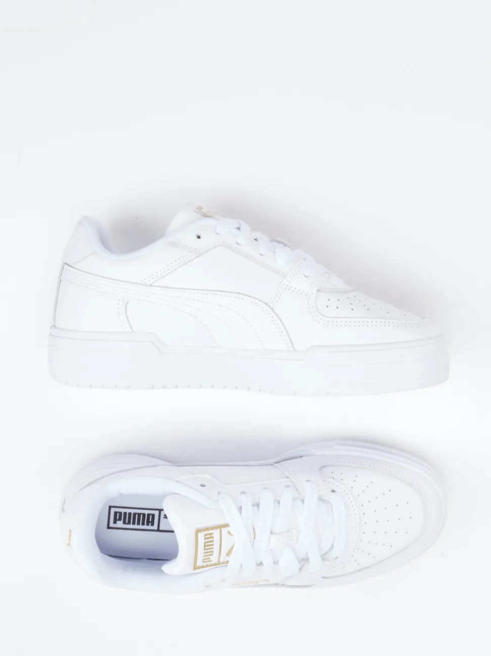 Puma – Sneaker aus Glattleder weiß mit Golddetails