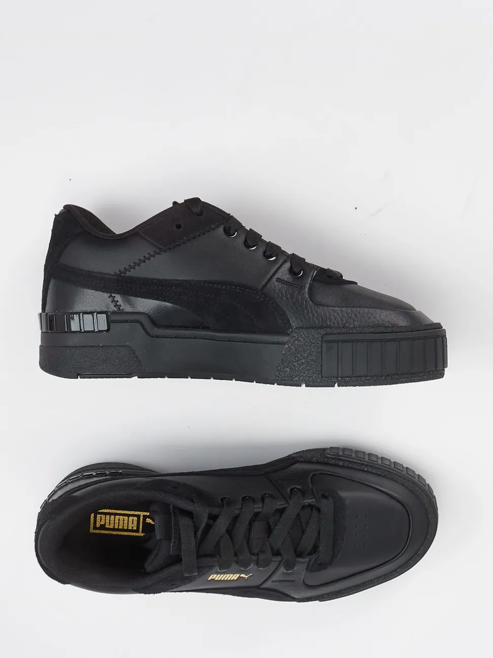 Puma – Sneaker aus Leder in Schwarz mit Goldakzenten